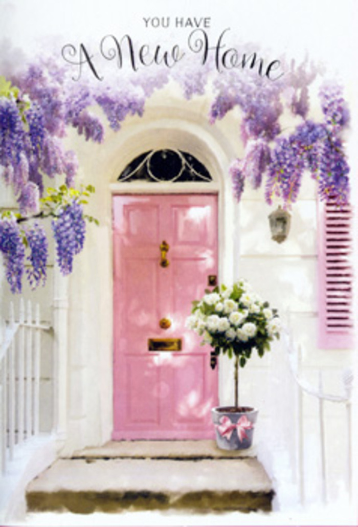 This evocative image shows a tranquil front door in Sipson, transformed into a gentle celebration by a cascade of wisteria and a thoughtfully placed arrangement of roses. Overhead, the wisteria drapes in soft, trailing clusters of lavender blossoms, each tiny flower forming part of a loose, fragrant curtain that frames the doorway with natural grace. The door itself is painted in a powdery pink, its subtle blush tone standing out against a whitewashed wall and matching shutter that recall the quiet charm of the cottages and family homes scattered around Sipson Village Green and Harmondsworth Lane. On the doorstep, just in front of the threshold, sits a cylindrical grey bucket with a lightly weathered surface, the kind of simple yet characterful container a florist might choose for an understated but elegant housewarming display. Rising from it, a full bouquet of white and cream roses creates a rounded dome of texture and softness, each bloom open enough to reveal its intricate spirals of petals. Between the roses, fresh green foliage peeks out and dips over the rim, adding rhythm and movement to the arrangement while suggesting a connection to the gardens and hedges nearby. Around the base of the bucket, a blush-pink satin ribbon is wrapped and tied into a tidy bow, with its tails resting gently across the stone step, mirroring the door's hue and unifying the composition. Dappled light from the wisteria above falls in mottled patterns across the whole scene, giving it a serene, almost cinematic quality. You can imagine this bouquet being delivered by Sipson Florist as a surprise congratulations for someone moving into a new home, greeting them with the soft fragrance of roses and wisteria and promising days filled with comfort, welcome, and shared moments within. The scene encapsulates the tender excitement of settling into a new chapter of life, expressed entirely through flowers, light, and gentle colour.